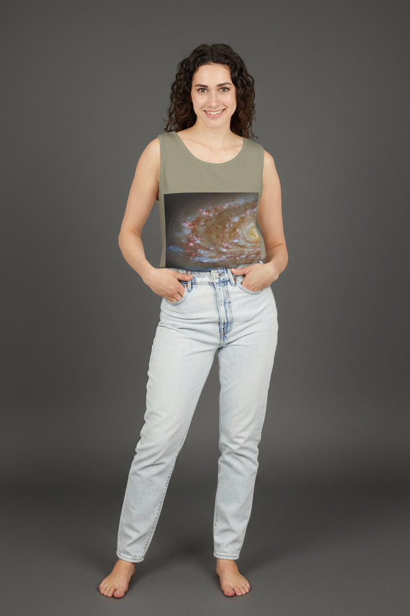 Woman wearing a sleeveless top with a galaxy print on a white background