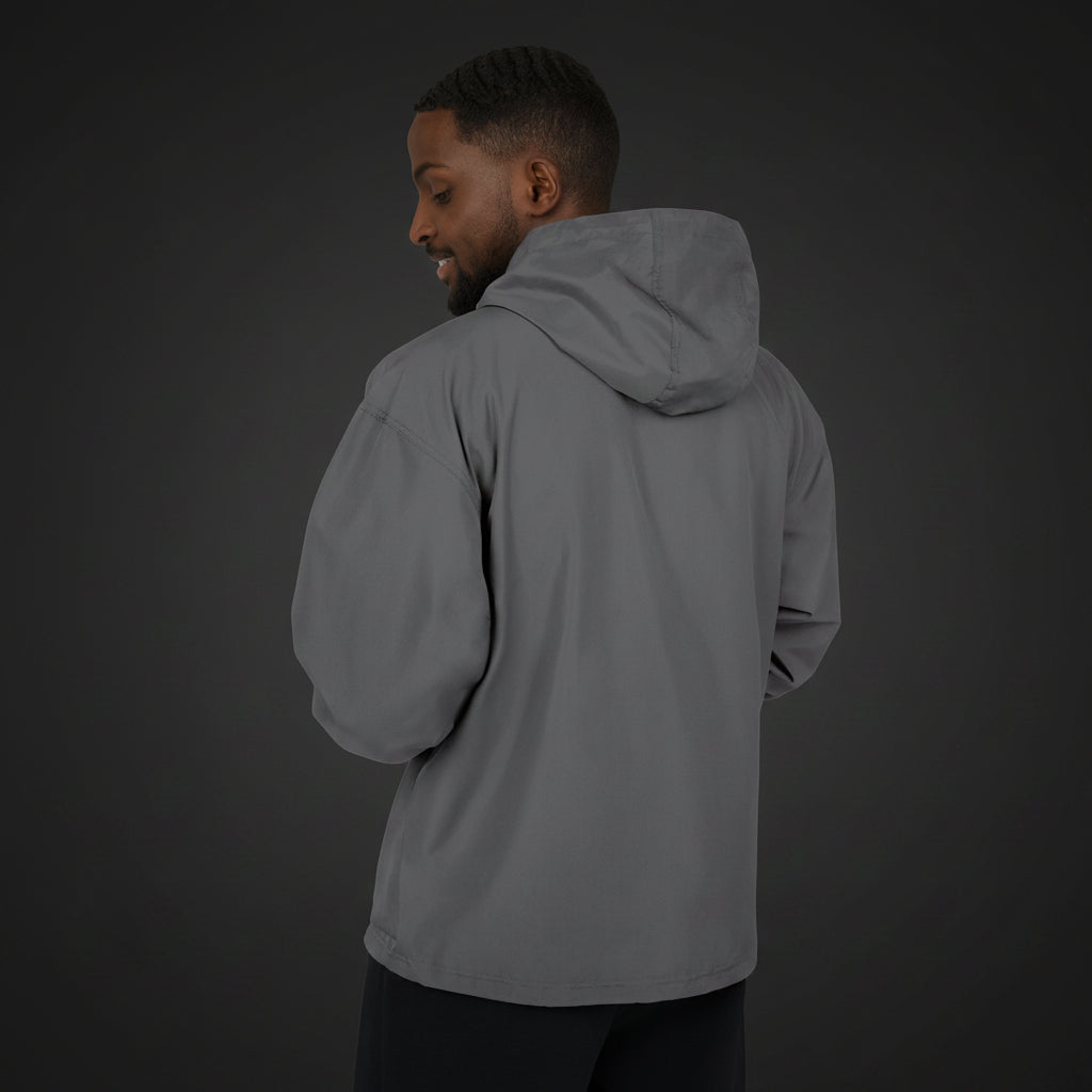 Man wearing a gray hooded jacket on a white background