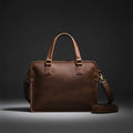 Brown leather briefcase with gold hardware on a white background