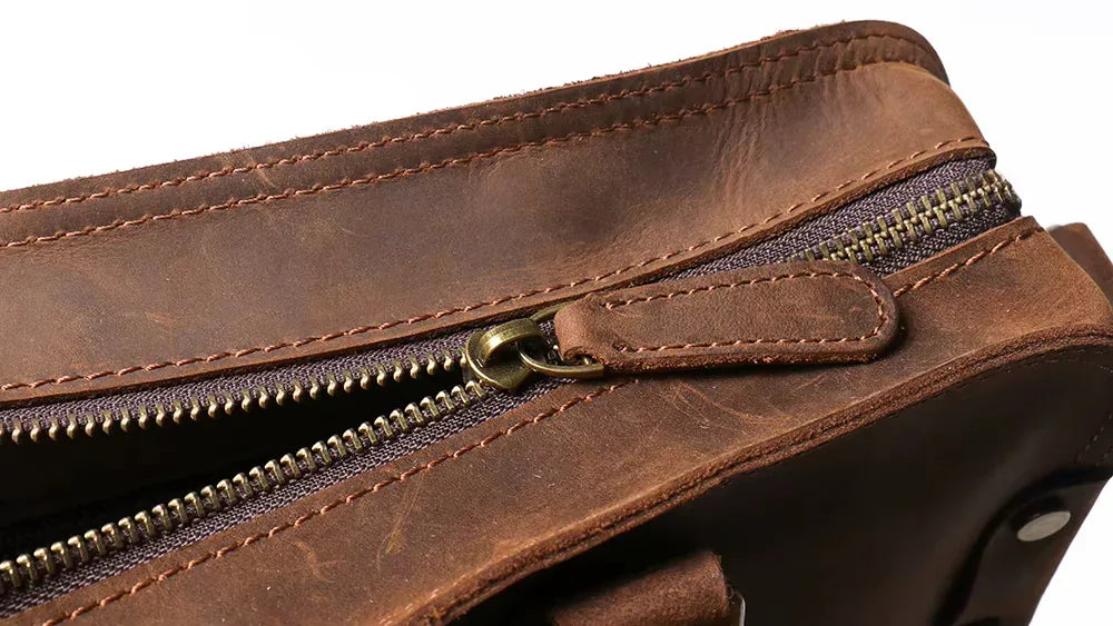 Close-up of a brown leather bag with a zipper