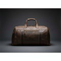 Brown leather duffel bag on a white background